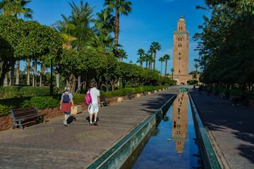 Morocco. Marrakesh. The minaret of the Koutoubia mosque with gardens and canals.