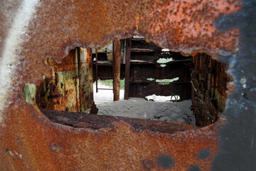 An abandoned rusty warship on the sand of the Baltic Sea. Hel.