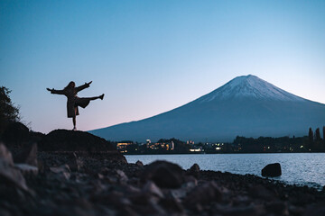 Happy tourist traveler woman or man enjoying on lake kawaguchiko with mount fuji in japan, spring...