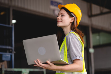 Female engineer using laptop computer for safety control checks or manufacturing maintenance work in factory building or construction site. woman engineer inspector working in industry product line