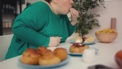 Hungry overweight female overeating salty junk food, sweet cake, stress eating