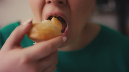 Close-up mouth of woman chewing sweet and salty food, stress eating disorder