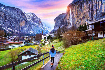 Tourist visiting village of Lauterbrunnen in the Bernese Oberland, Switzerland. - obrazy, fototapety, plakaty