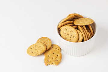 Oval crispy cookies or crackers in white mold on white background isolated  with copy space