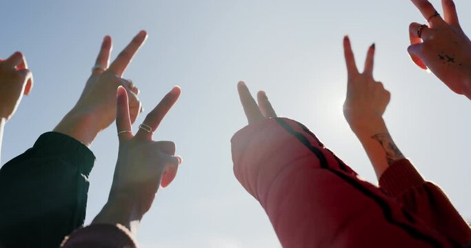 Peace sign, blue sky and hands of friends in the air for party, freedom or counting together. Support, trust and closeup fingers of people with a gesture in solidarity in nature for celebration