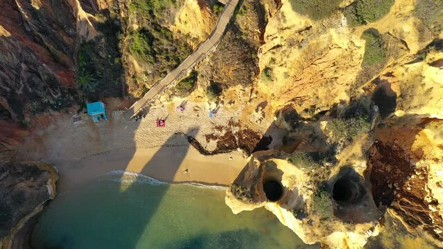 Camilo beach (Praia do Camilo) in Lagos, Algarve, Portugal. Wooden footbridge to the beach Praia do Camilo, Portugal. Picturesque view of Praia do Camilo beach in Lagos, Algarve region, Portugal.