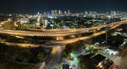 View from above of american big freeway intersection in Miami, Florida at night with fast moving...