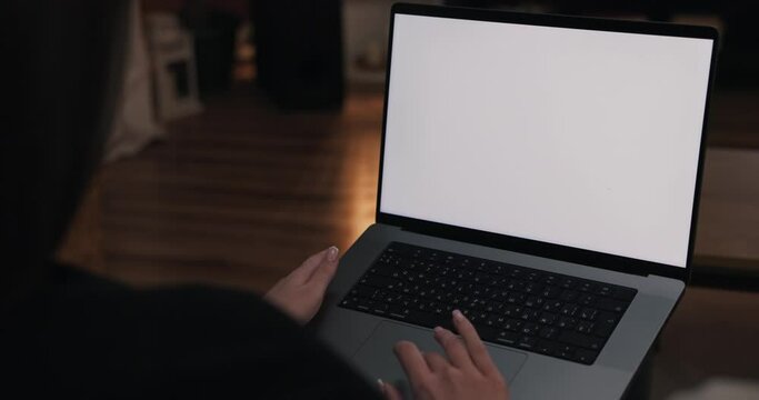 Woman holds laptop with white screen mockup working studying from hone online job study education. Tutor concept education. Young teacher tutore having video oline lesson.