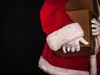 Santa Claus in traditional costume delivering boxes