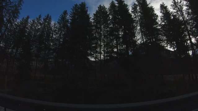 TRAVELLING SHOT - Beautiful alpine winter view with a building and the famous Ehrwalder Sonnenspitze and Zugspitze in the background at the Ehrwalder Alm near Ehrwald, Tyrol, Austria.