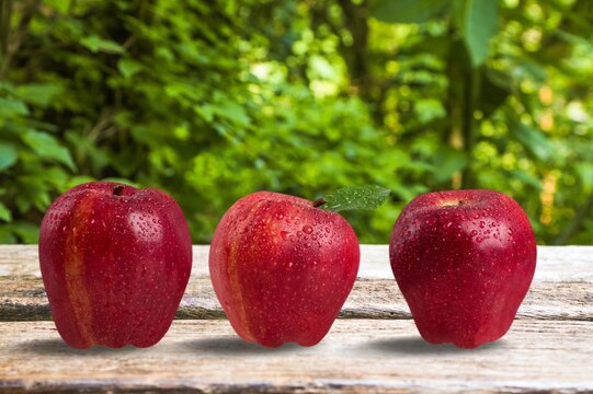 Set of fresh ripe red apples on the desk