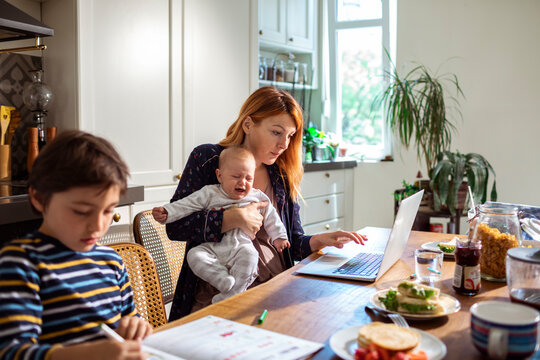 Multi tasking Mother Working from Home with Children