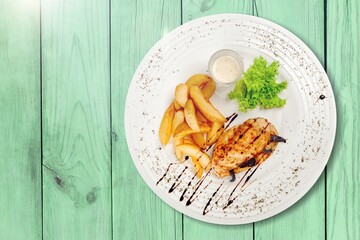 Plate with tasty hot french fries on plate