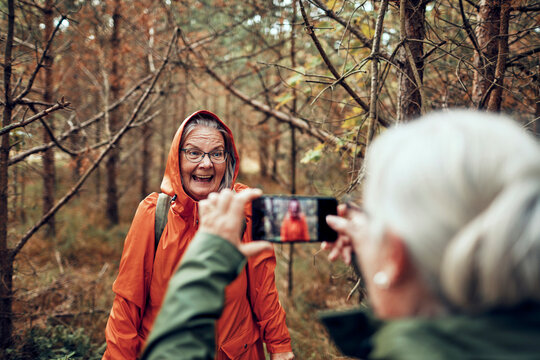 Senior woman posing for picture on a nature hike