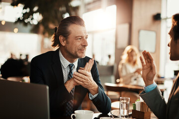 Focused Conversation Between Business Colleagues in a Cafe