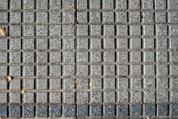 cement and granite floor texture in the form of small squares in light gray and dark gray color