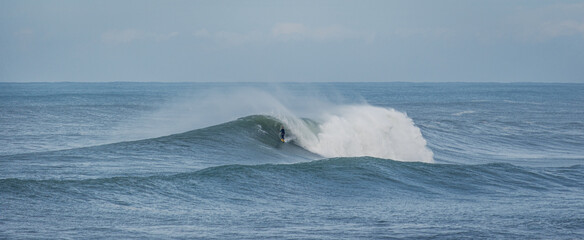 Surfer in huge wave