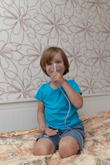 Blue-eyed boy being treated with nebulizer, child treating lungs, breathing medication