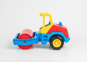 Obraz na płótnie Canvas Plastic toy models of construction vehicles. Asphalt roller.