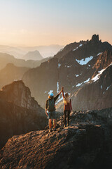 Couple climbing mountains together success concept romantic vacations in Norway man and woman...