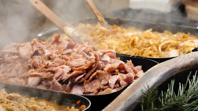 Delicious hot dishes outdoors traditional festive market catering service, food preparation, cooking and serving hot steamy food, tasty, delicious meals, variety of different foods, outdoors, closeup