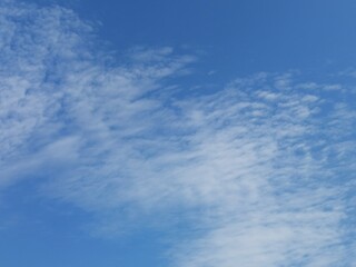Full frame of pretty blue sky with unusual scudding cloud formation