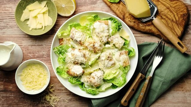 Caesar salad. Classic Caesar salad with romaine lettuce, croutons, baked chicken fillet, Parmesan cheese and dressed with white sauce