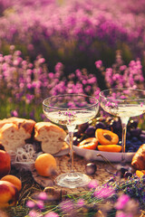 Picnic with wine in a lavender field. Selective focus.
