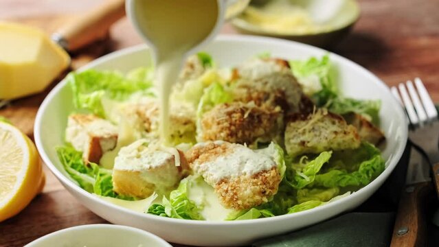 Caesar salad. Classic Caesar salad with romaine lettuce, croutons, baked chicken fillet, Parmesan cheese and dressed with white sauce