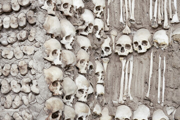 Chapel of Bones in the city of Évora. Fragment of a wall with embedded human skeletons .
