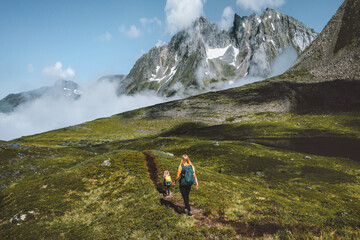 Family adventure in the mountains of Norway, mother with daughter backpacking outdoor hiking...