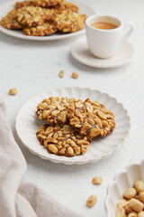 A heap of Portugues traditional peanut cookies known as Bolachas de Amendoim on the white plate