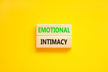 Emotional intimacy symbol. Concept words Emotional intimacy on beautiful wooden blocks. Beautiful yellow table yellow background. Psychology emotional intimacy concept. Copy space.
