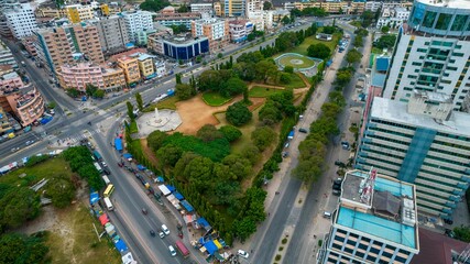 an aerial view of a city in the afternoon, with many vehicles parked in the