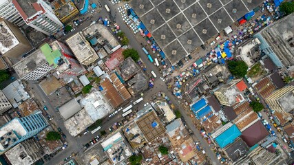 an aerial view of a city filled with buildings, cars and trash