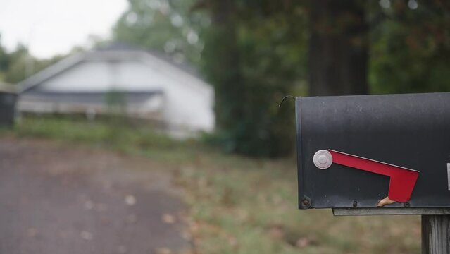 Mailbox on empty street with flap down during fall and overcast