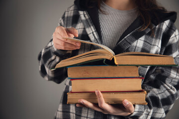 woman holding books in her hands