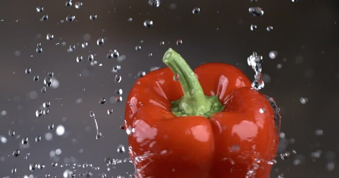 Super slow-motion macro shot of ripe red fresh red pepper in the kitchen while cooking with pure water at 1000 fps f