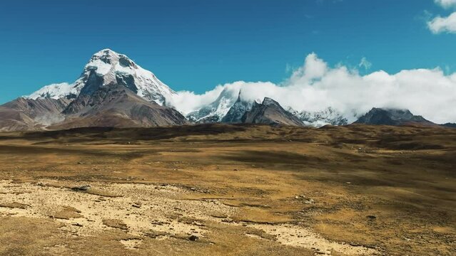 Drone view of snowy high mountains,Dolly zoom
