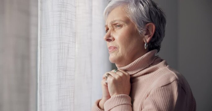 Depression, sad and senior woman in home with mourning and memory with mental health emotion. Elderly female person, sorry and anxiety in house feeling disappointed in retirement with grief by window