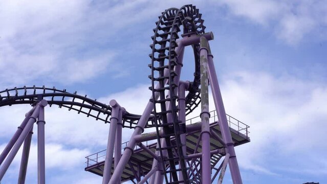 Roller coaster attraction. The amusement cart makes a circular loop, turns upside down. High quality 4k footage
