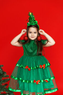 Happy child in Christmas tree green costume. Christmas eve time. Holiday concept. Buying presents concept