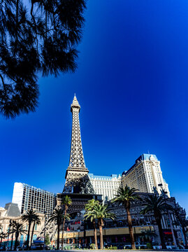 Las Vegas, USA; January 18, 2023: Vertical photograph of the Eiffel Tower of the Paris Las Vegas Strip hotel, casino and resort on the boulevard of the city of vice, gambling and sin under a blue sky.