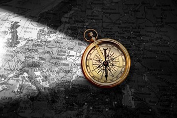 Magnetic retro old compass and world map.