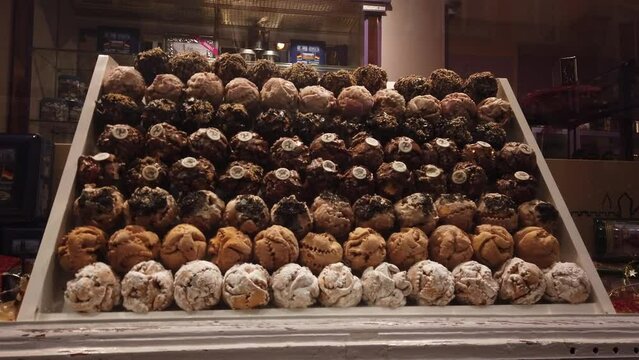 Fussen, Germany, December 6, 2022: Stefanie Diller Schneeballentraume traditional Snow Balls. Schneeball is a sweet pastry in many varieties with chocolate, pistachio, or sugar.