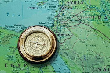Magnetic retro old compass and world map.