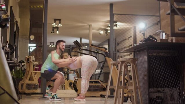 Couple in love dancing bachata and tango. Boy and girl having fun during exercise break in a fitness studio.