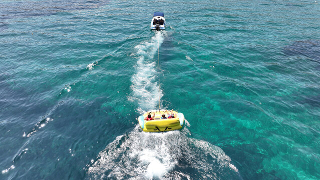 Aerial drone photo of extreme powerboat donut water-sports cruising in high speed in tropical turquoise bay