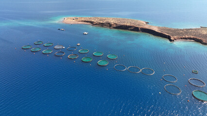 Aerial drone photo of self feeding sea bass and sea bream fish farming unit in Mediterranean deep...