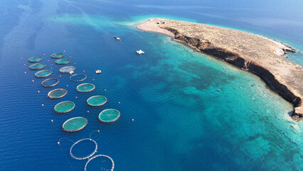 Aerial drone photo of self feeding sea bass and sea bream fish farming unit in Mediterranean deep...